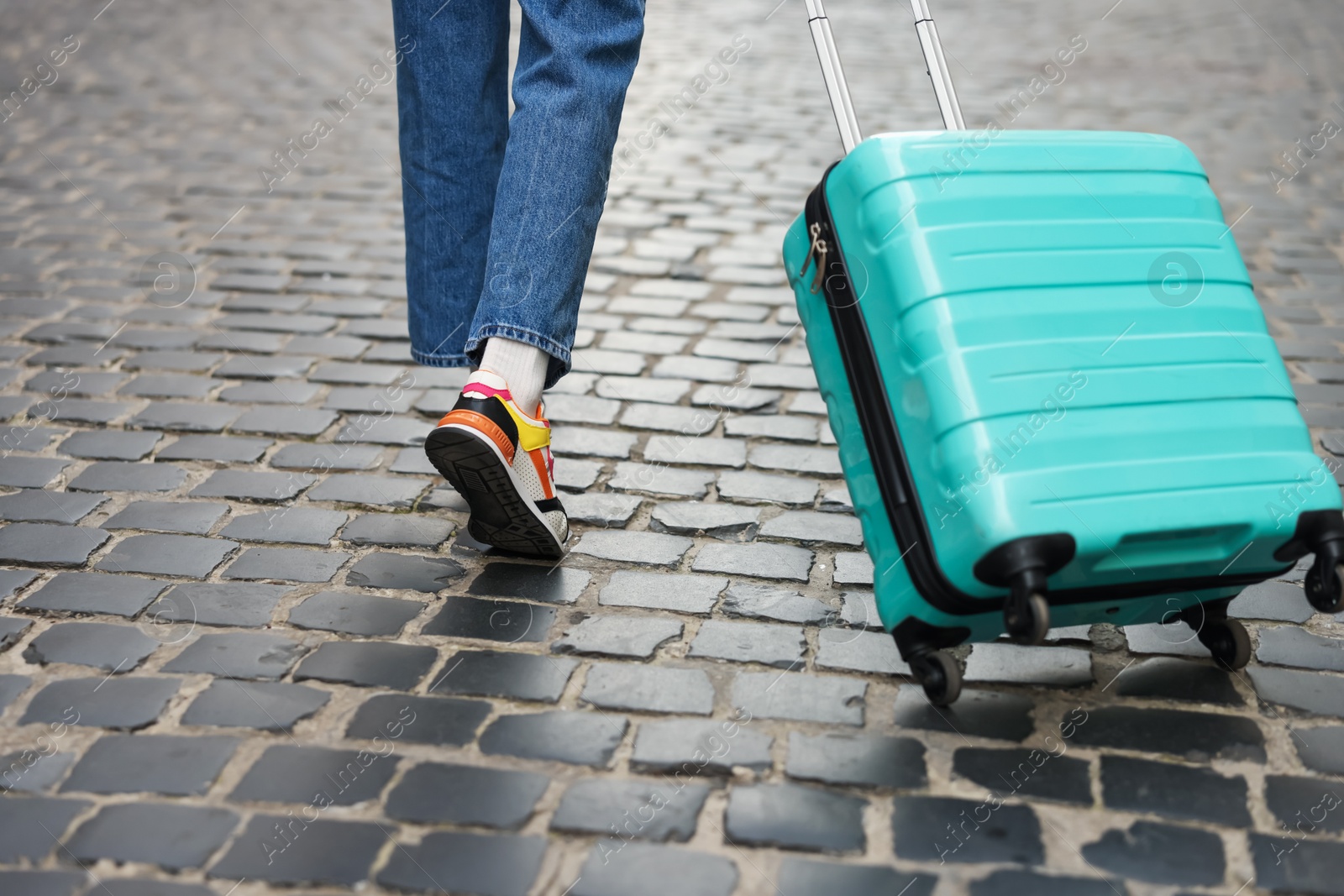 Photo of Goodbye. Woman with luggage walking on city street, closeup