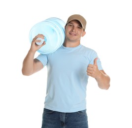 Photo of Smiling delivery man with cooler bottle of water showing thumbs up on white background