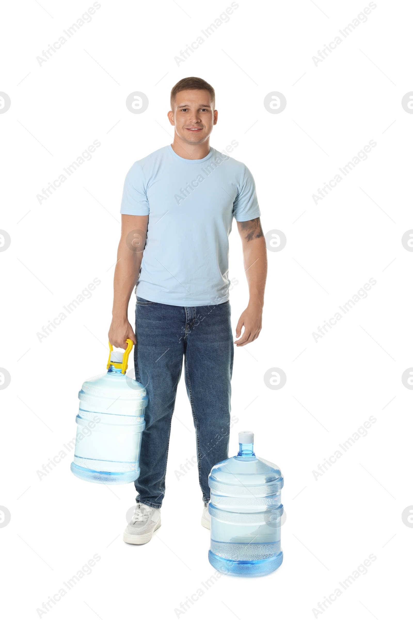 Photo of Smiling delivery man and cooler bottles of water on white background