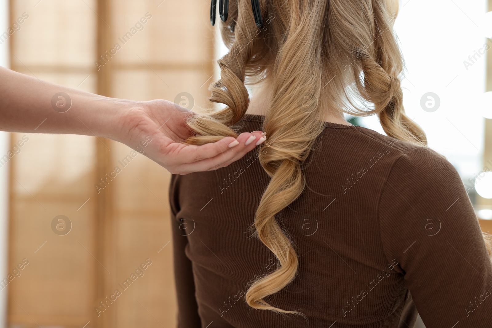 Professional hairstylist working with client in salon, closeup Photo of Professional hairstylist working with client in salon, closeup