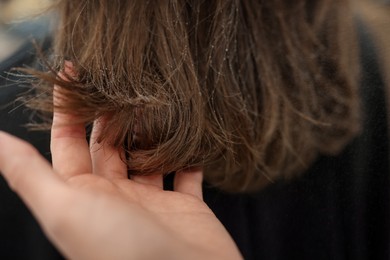 Photo of Professional hairstylist working with client in salon, closeup