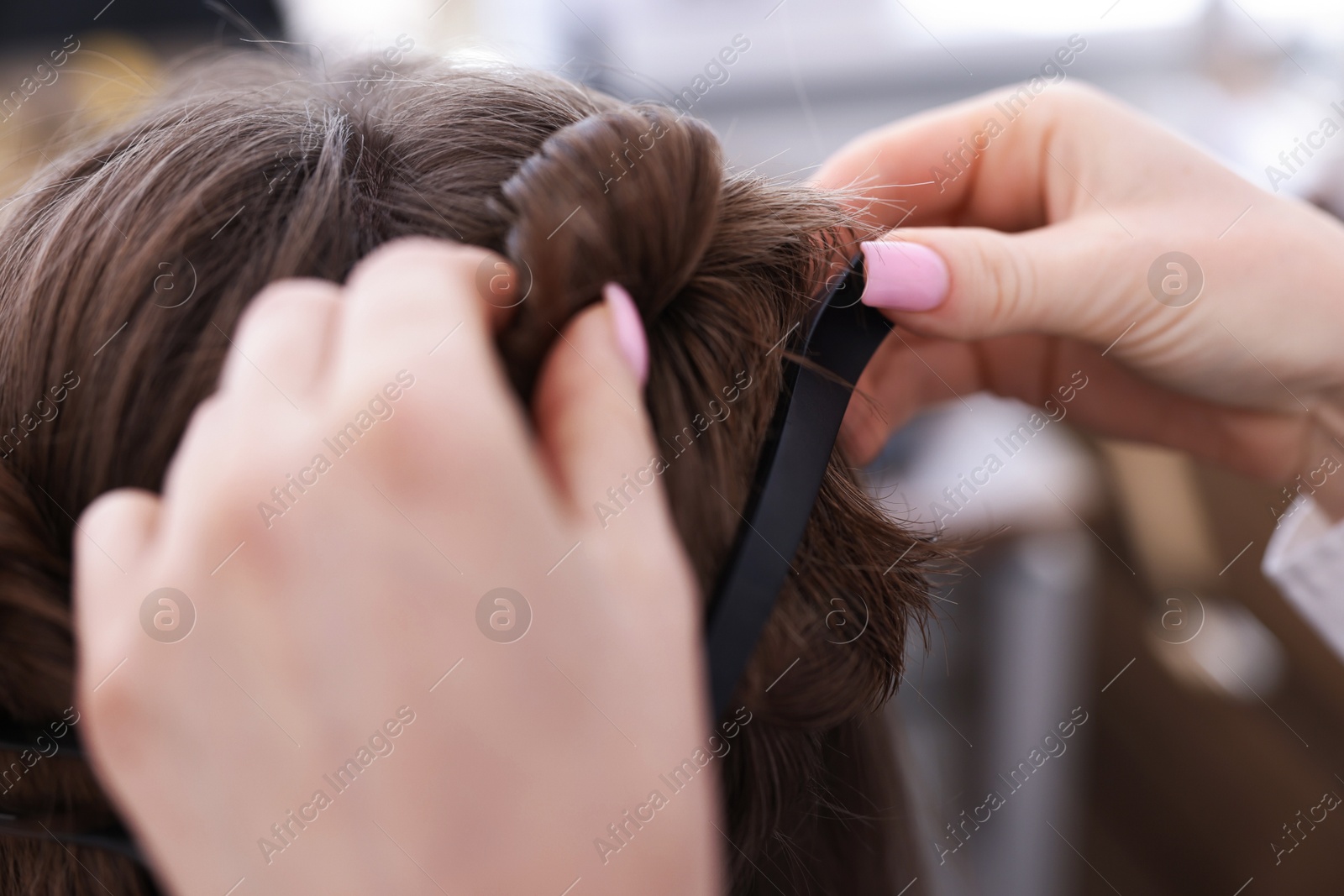 Professional hairstylist working with client in salon, closeup Photo of Professional hairstylist working with client in salon, closeup