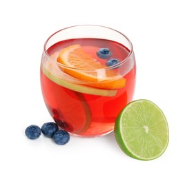 Photo of Tasty punch with slices of fruits and blueberries in glass isolated on white. Refreshing drink