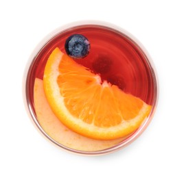 Photo of Tasty punch with slices of fruits and blueberries in glass isolated on white, top view. Refreshing drink