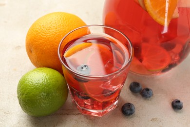 Photo of Tasty punch, fruits and berries on light gray table, closeup