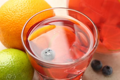 Photo of Tasty punch in glasses and fruits on table, closeup