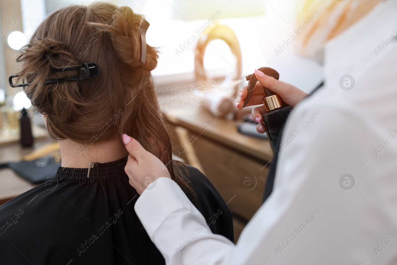 Professional hairstylist working with client in salon, closeup Photo of Professional hairstylist working with client in salon, closeup