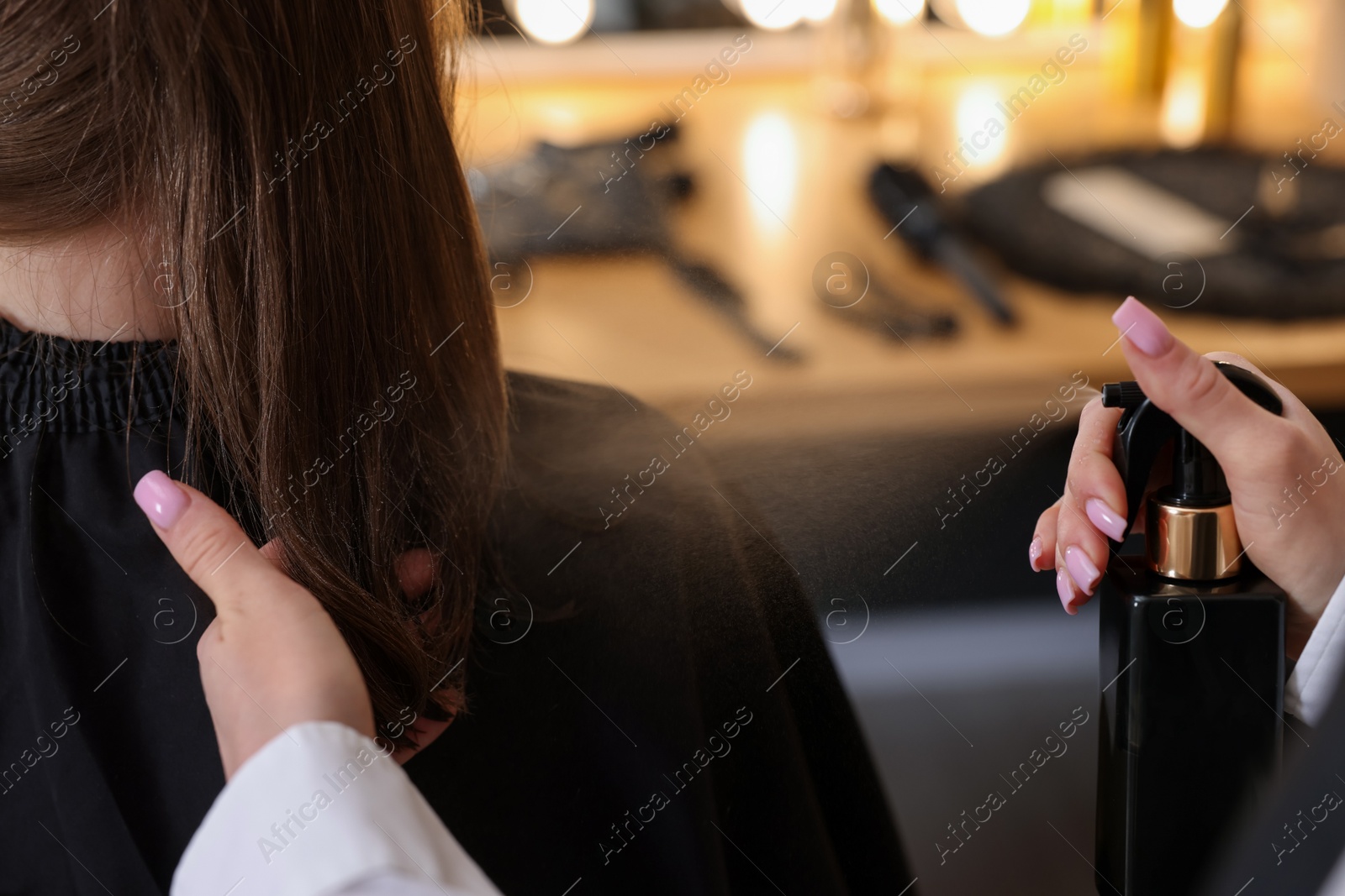 Professional hairstylist working with client in salon, closeup Photo of Professional hairstylist working with client in salon, closeup