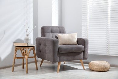 Photo of Comfortable armchair and decor in light room