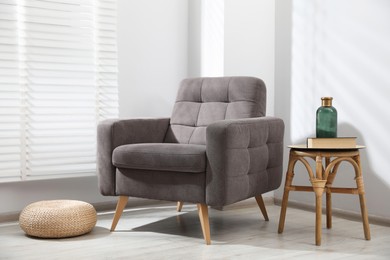 Photo of Comfortable armchair and decor in light room