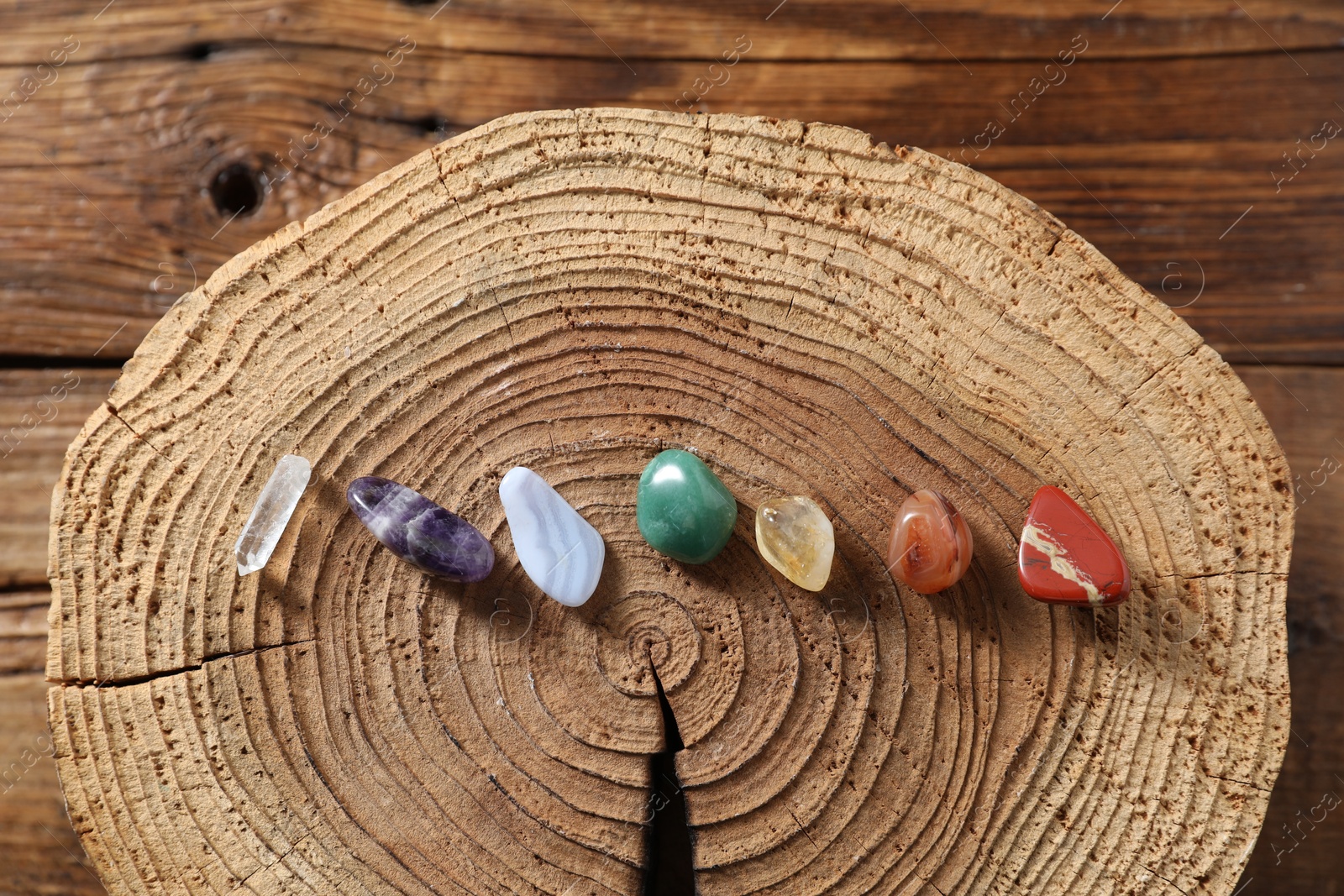 Photo of Aura. Different natural mineral stones on wooden table, flat lay
