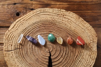 Photo of Aura. Different natural mineral stones on wooden table, flat lay