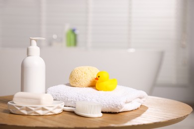 Photo of Baby accessories and bathing products on wooden table in bathroom. Space for text