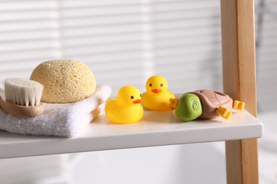 Photo of Baby bath accessories on rack indoors, closeup
