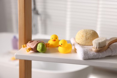 Photo of Baby bath accessories on rack indoors, closeup