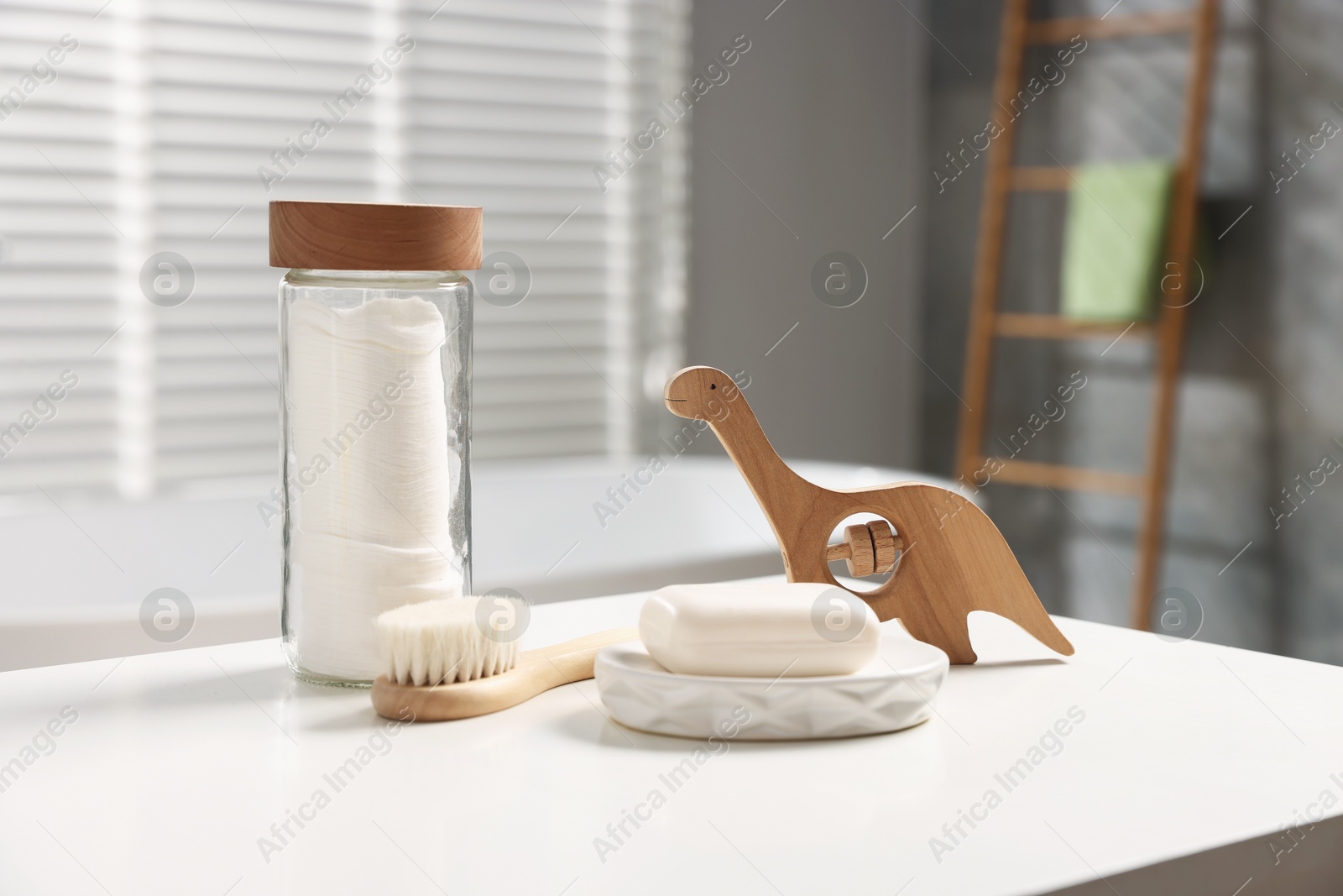 Photo of Baby bath accessories on white table in bathroom
