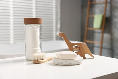 Photo of Baby bath accessories on white table in bathroom