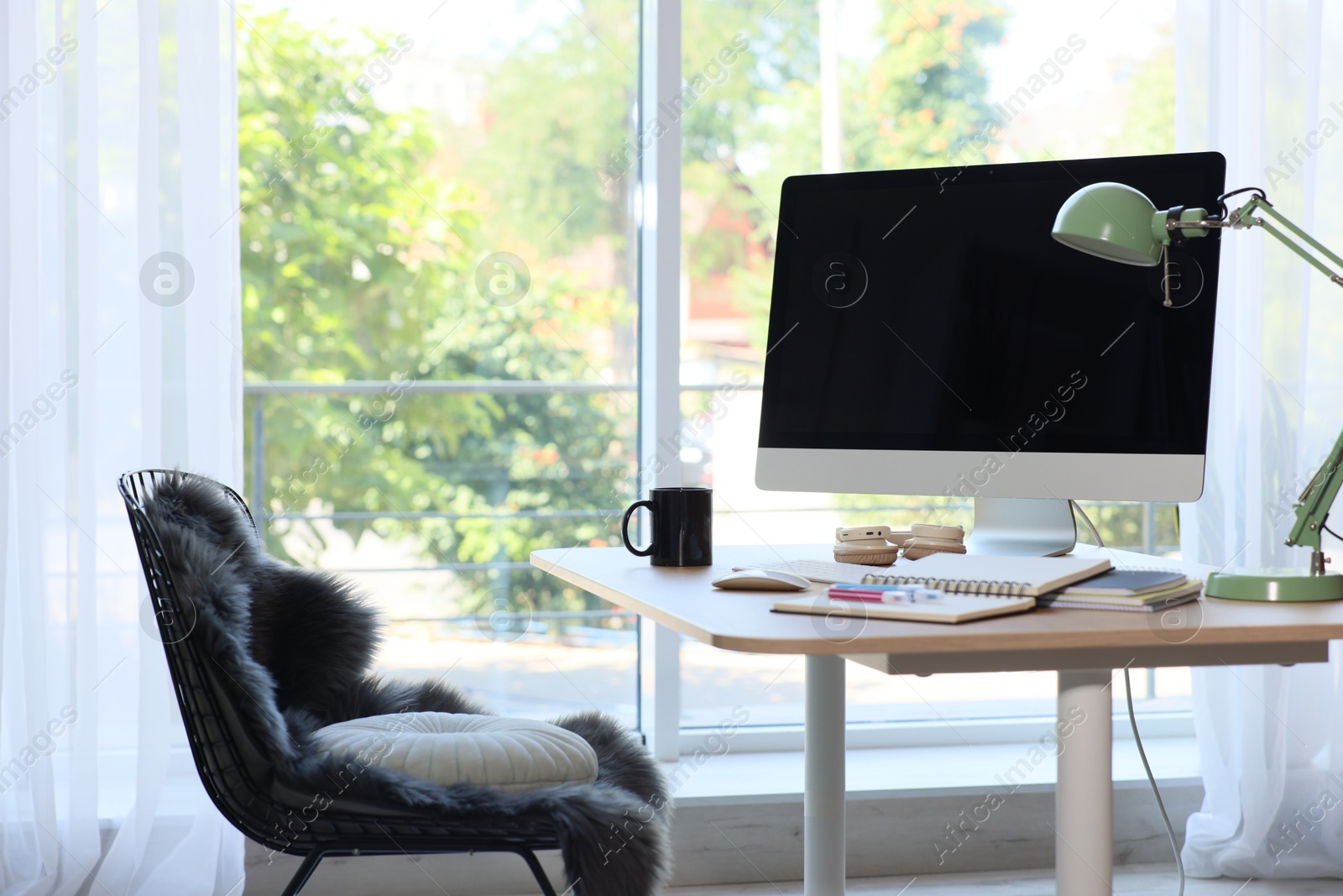 Photo of Home workspace. Modern computer and stationery on wooden desk indoors