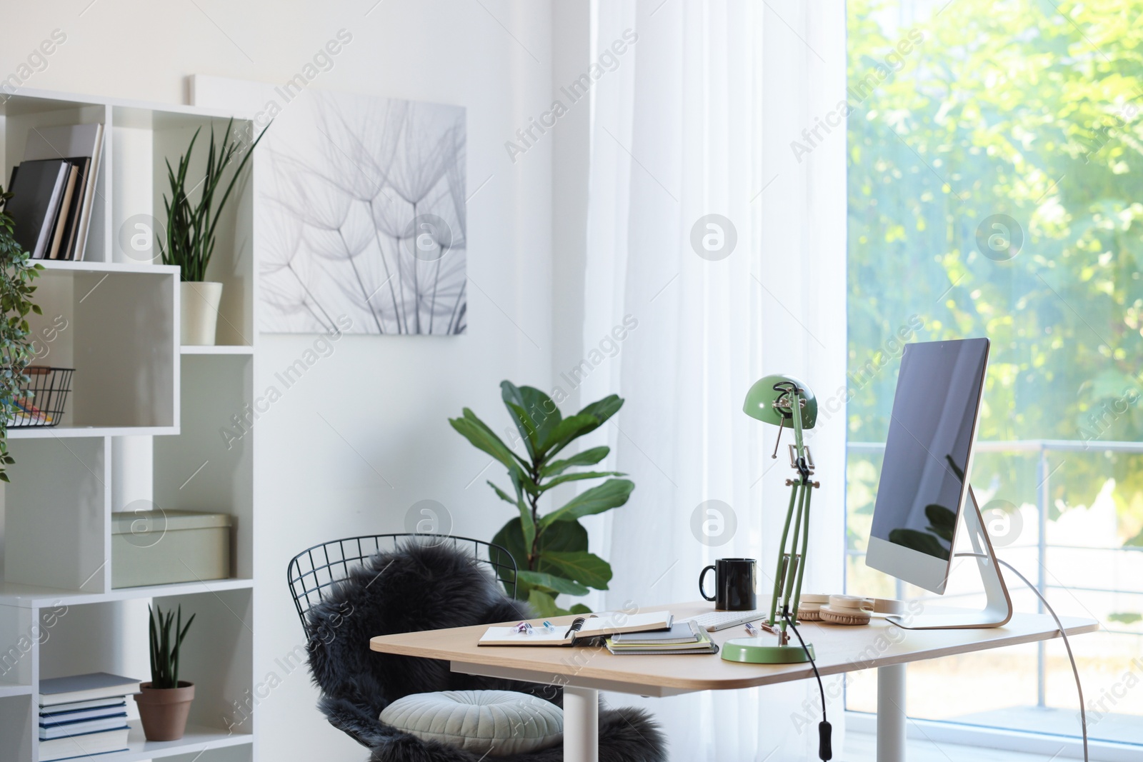 Photo of Home workspace. Modern computer, houseplant and stationery on wooden desk indoors