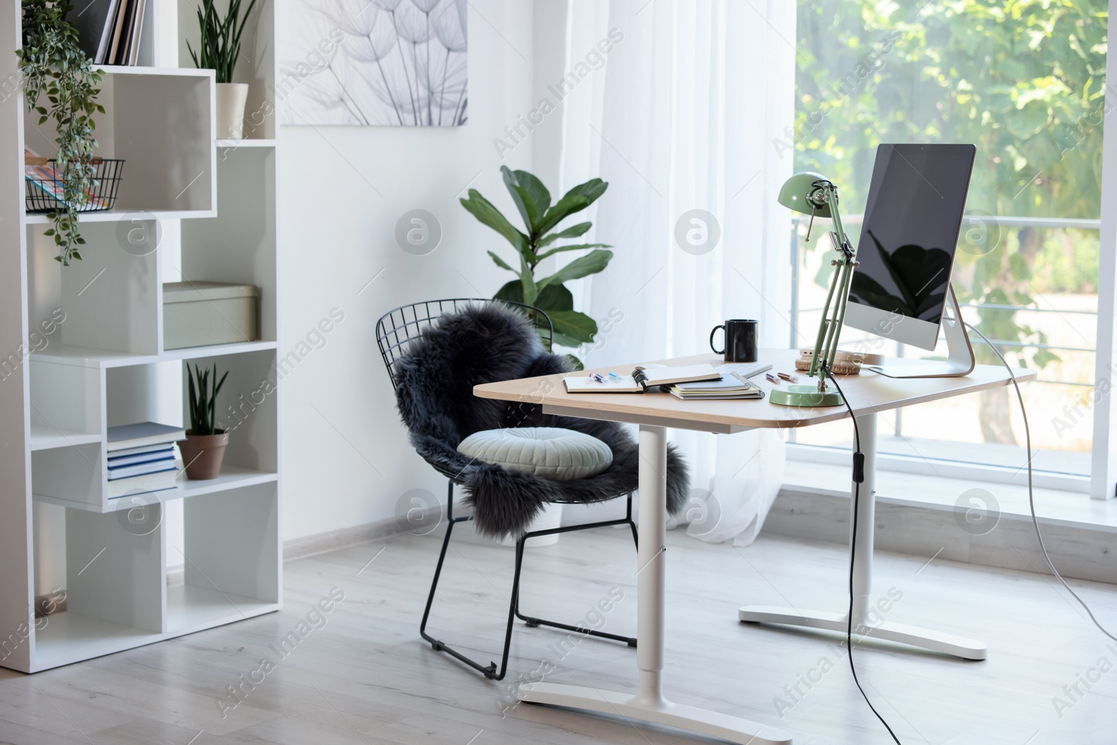 Photo of Home workspace. Modern computer, houseplant and stationery on wooden desk indoors