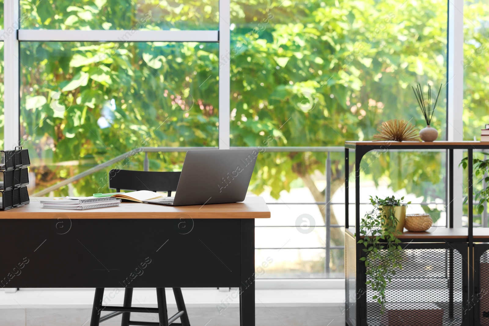 Home workspace. Modern laptop and stationery on wooden desk indoors Photo of Home workspace. Modern laptop and stationery on wooden desk indoors