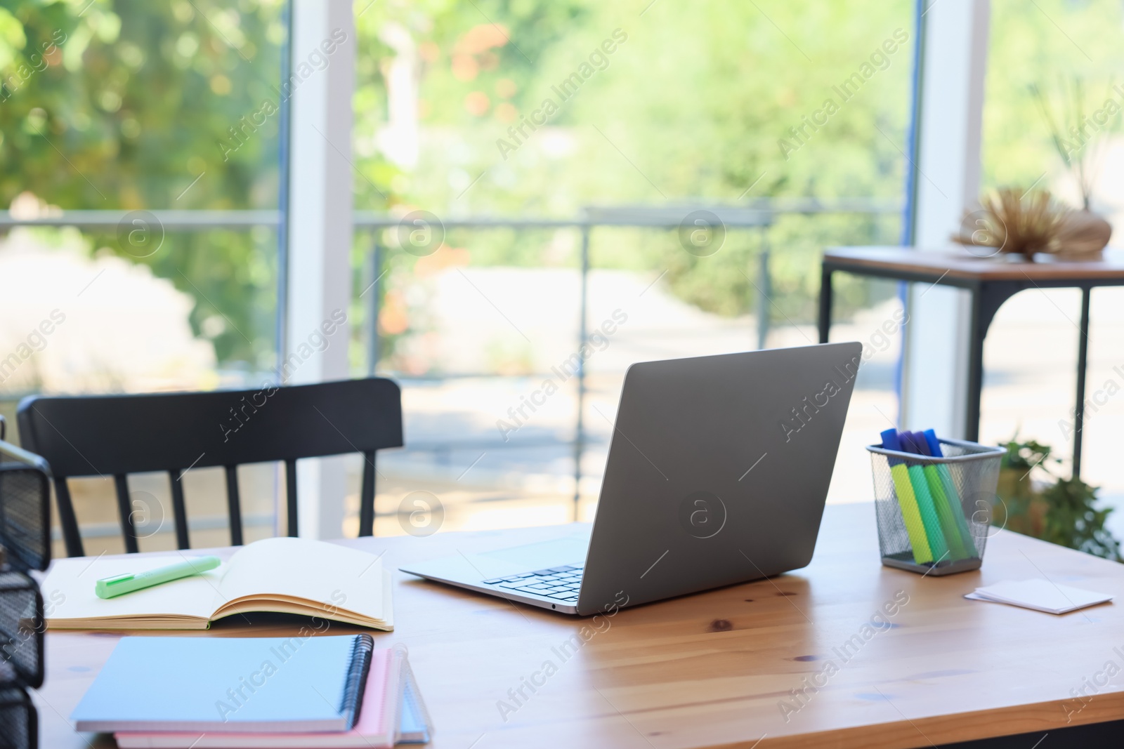 Photo of Home workspace. Modern laptop and stationery on wooden desk indoors