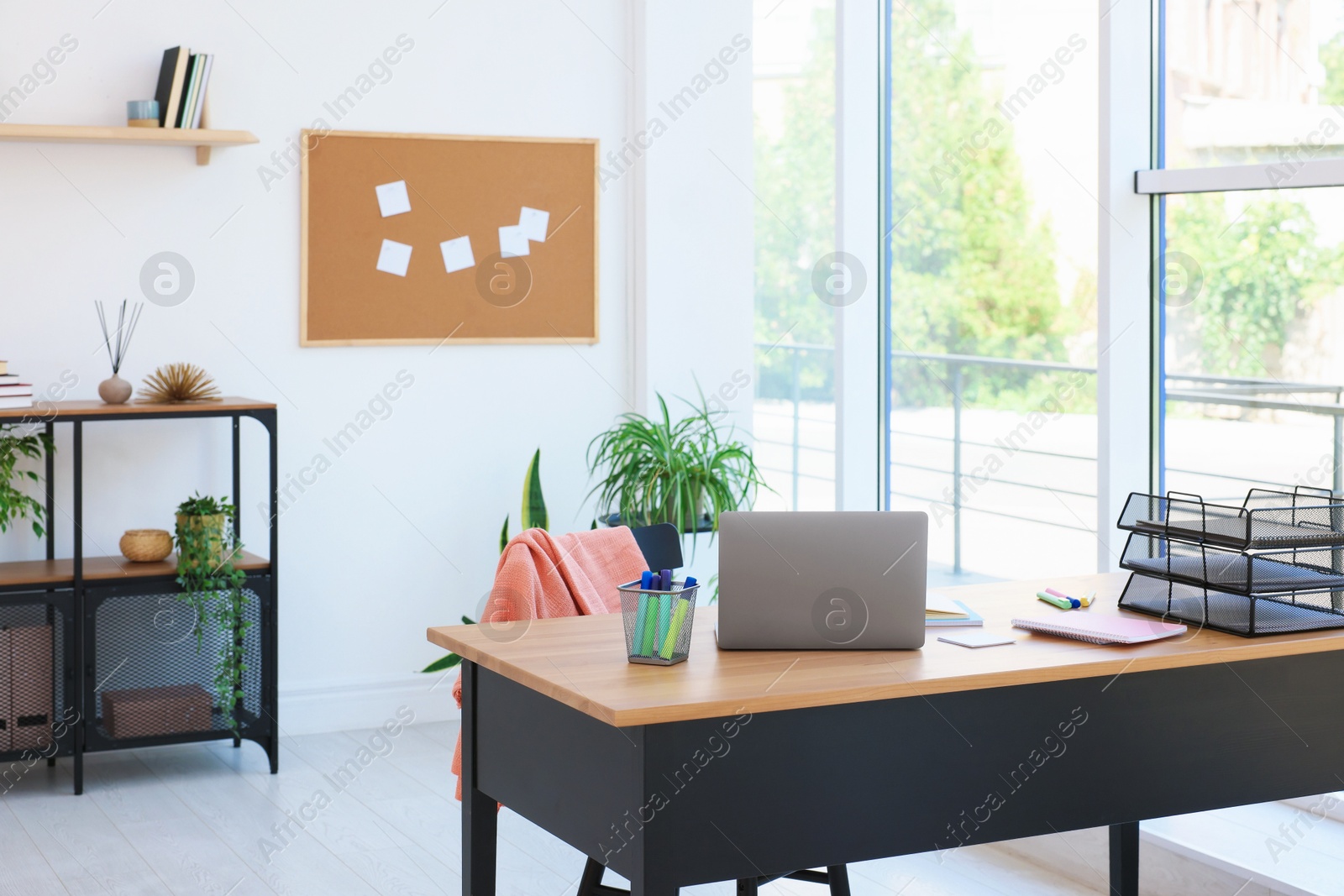 Photo of Home workspace. Modern laptop and stationery on wooden desk indoors