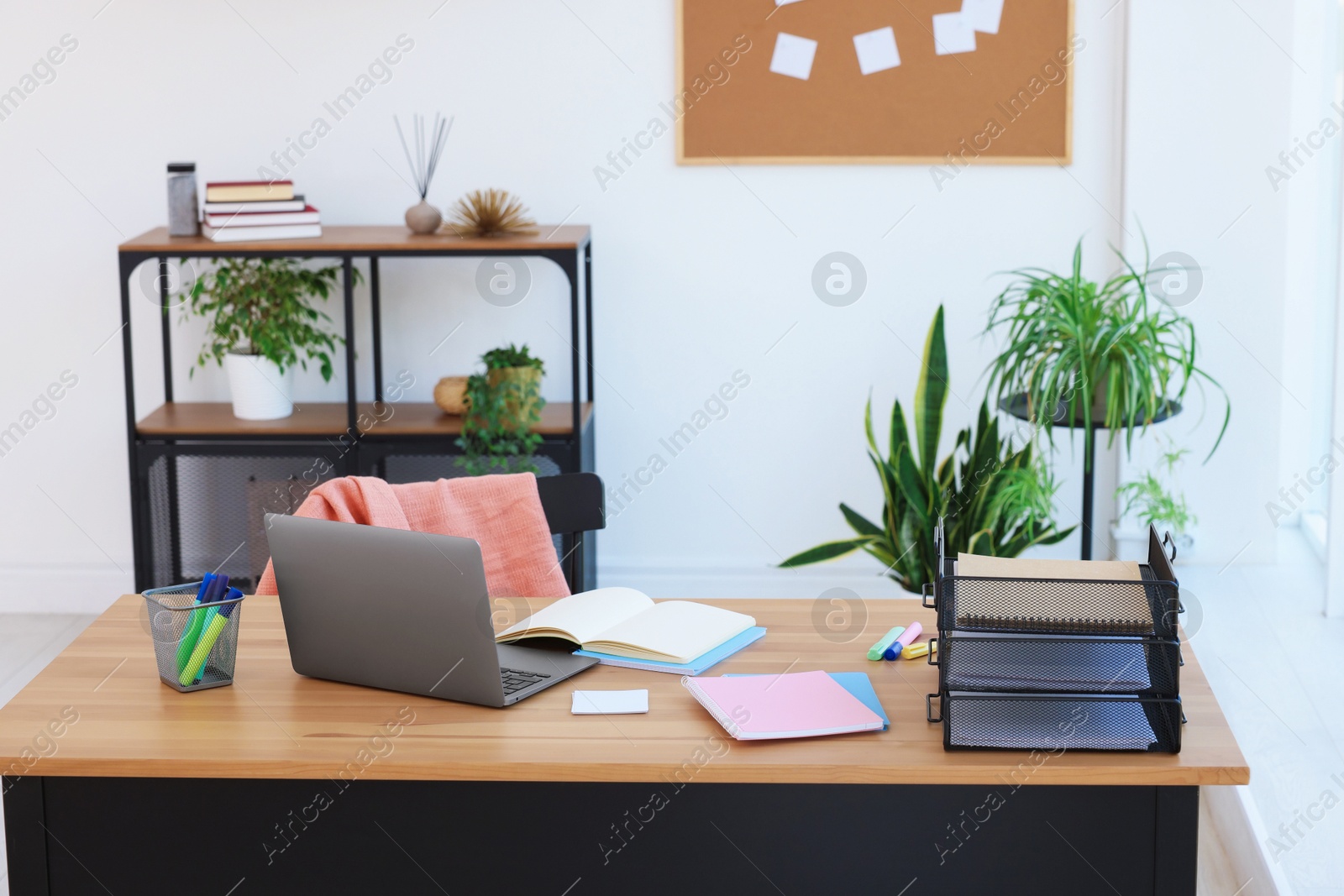 Photo of Home workspace. Modern laptop and stationery on wooden desk indoors