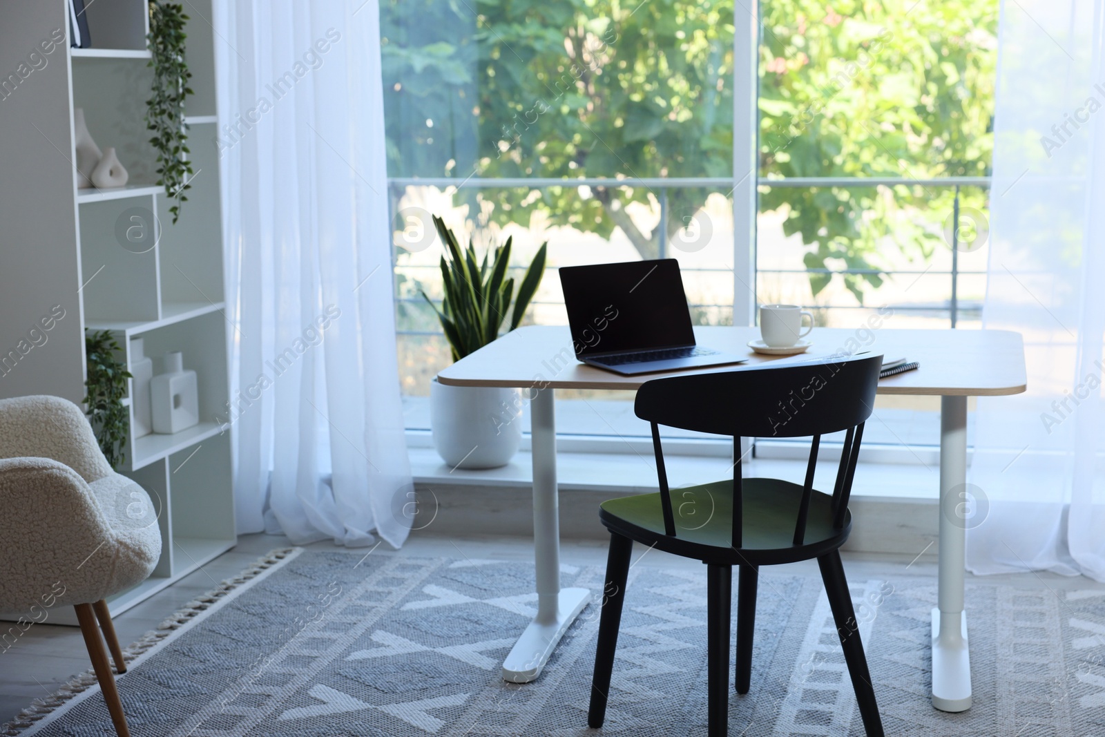 Photo of Home workspace. Modern laptop and stationery on wooden desk indoors
