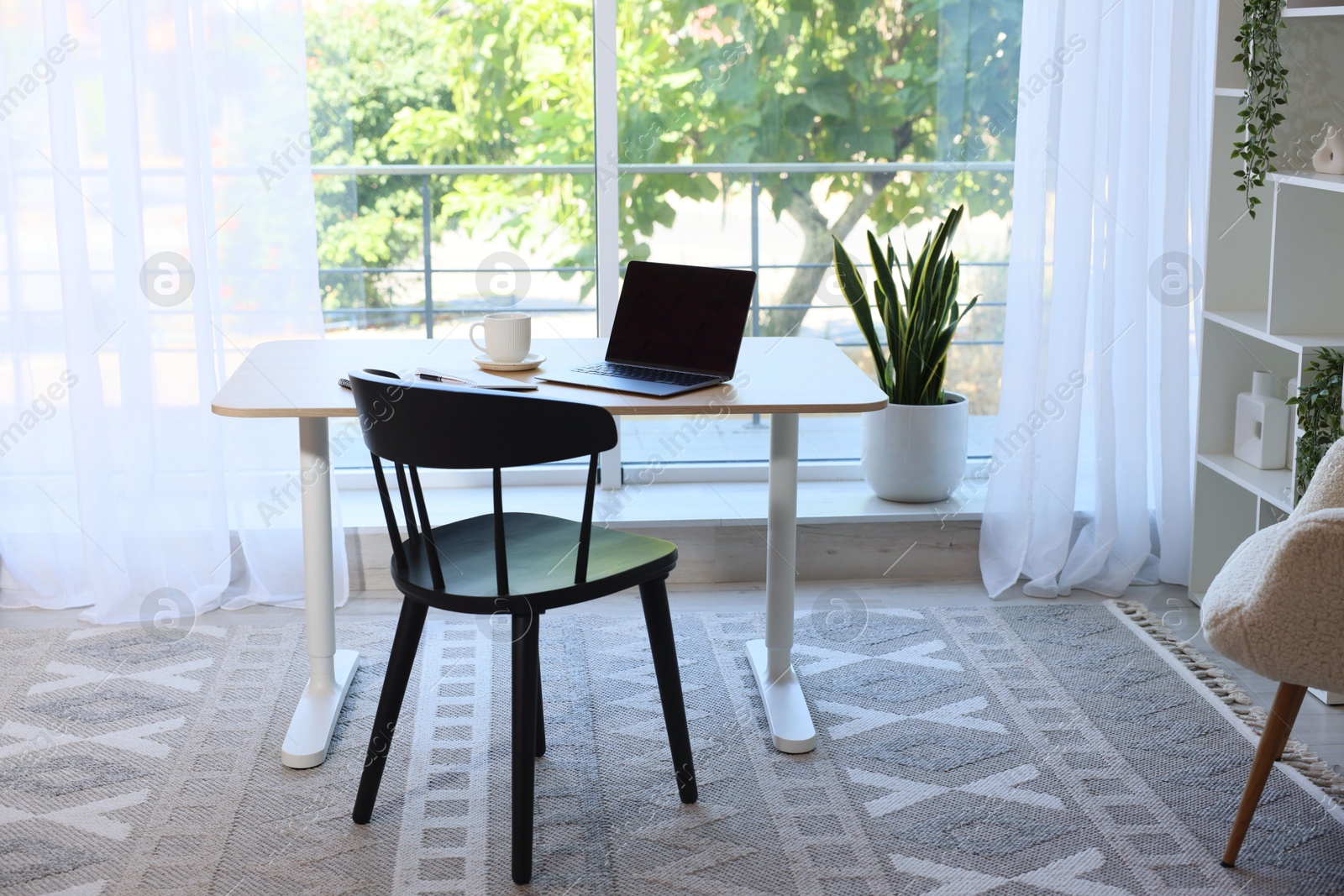 Photo of Home workspace. Modern laptop and stationery on wooden desk indoors