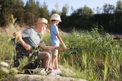 Photo of Grandfather and his nephew fishing together outdoors