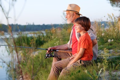 Photo of Grandfather and his nephew fishing together outdoors