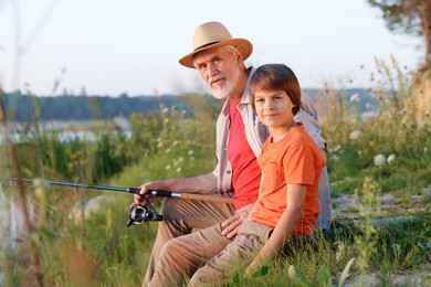 Photo of Grandfather and his nephew fishing together outdoors
