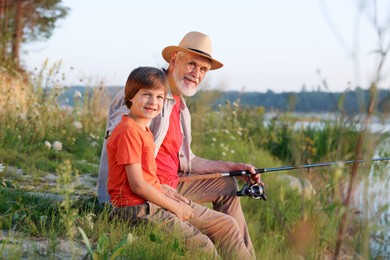 Photo of Grandfather and his nephew fishing together outdoors