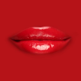 Image of Woman's lips against background matching color of her lipstick