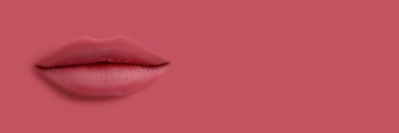 Image of Woman's lips against background matching color of her lipstick. Banner design with space for text