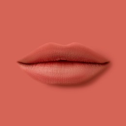 Image of Woman's lips against background matching color of her lipstick