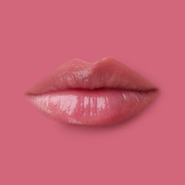 Image of Woman's lips against background matching color of her lipstick