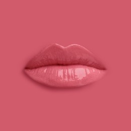 Image of Woman's lips against background matching color of her lipstick