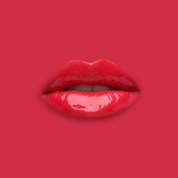 Image of Woman's lips against background matching color of her lipstick