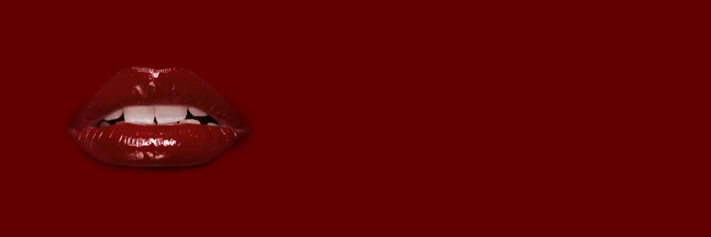 Image of Woman's lips against background matching color of her lipstick. Banner design with space for text