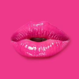 Image of Woman's lips against background matching color of her lipstick