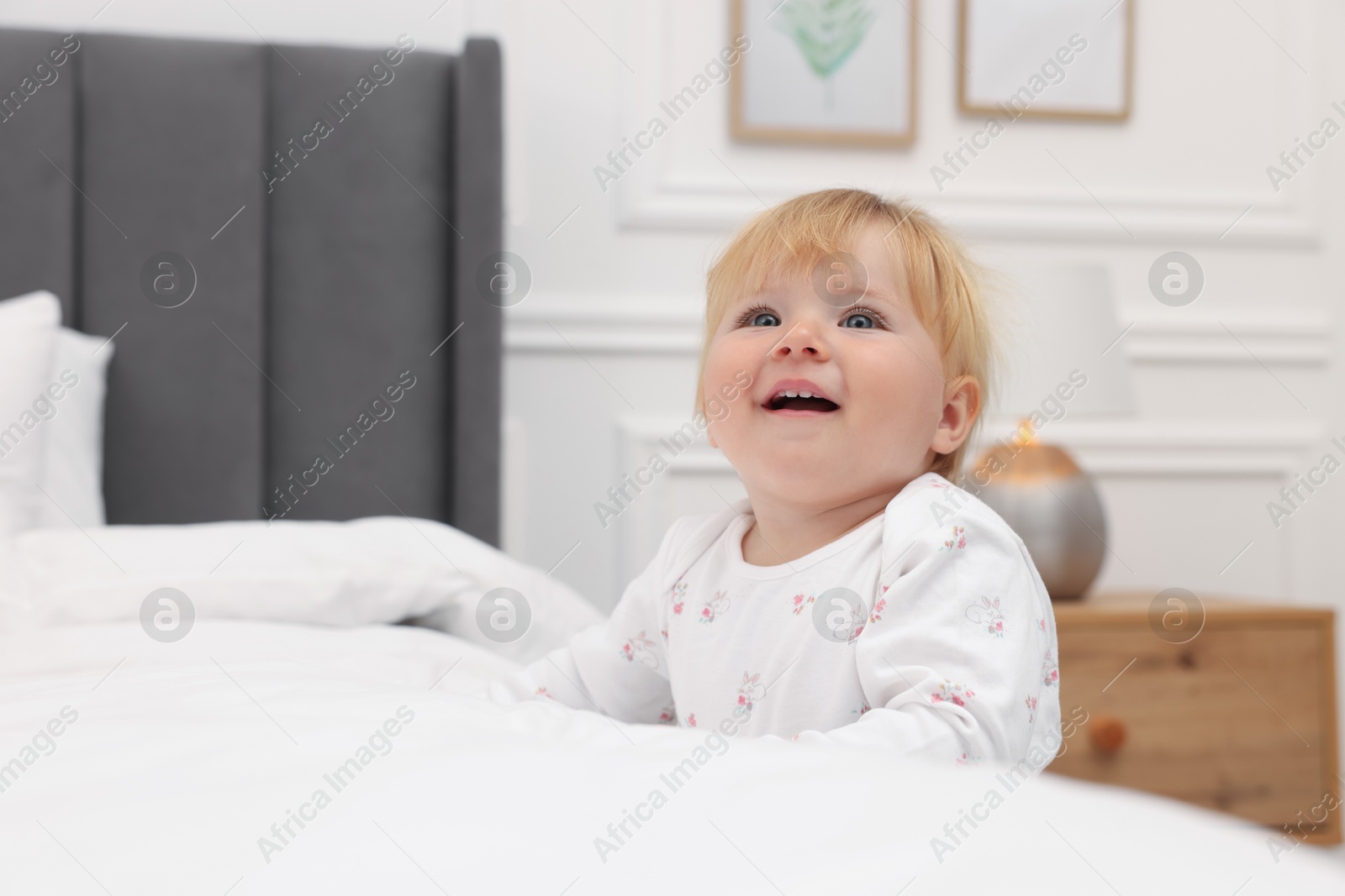 Happy baby leaning on bed at home Photo of Happy baby leaning on bed at home