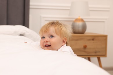 Photo of Happy baby leaning on bed at home