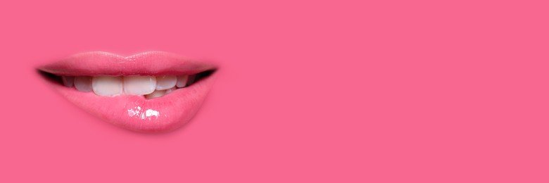 Image of Woman's lips against background matching color of her lipstick. Banner design with space for text