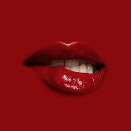Image of Woman's lips against background matching color of her lipstick