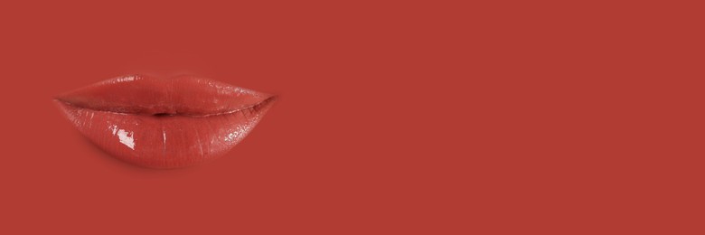 Image of Woman's lips against background matching color of her lipstick. Banner design with space for text