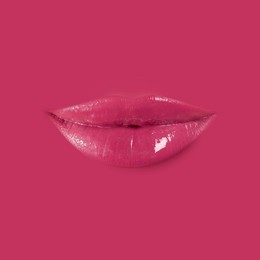 Image of Woman's lips against background matching color of her lipstick