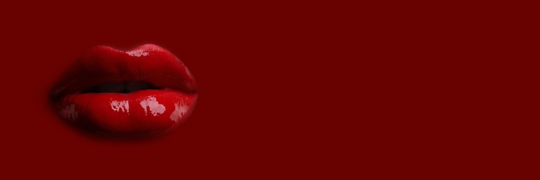 Image of Woman's lips against background matching color of her lipstick. Banner design with space for text