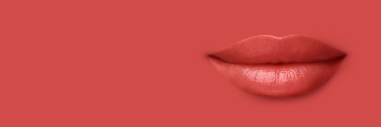 Image of Woman's lips against background matching color of her lipstick. Banner design with space for text